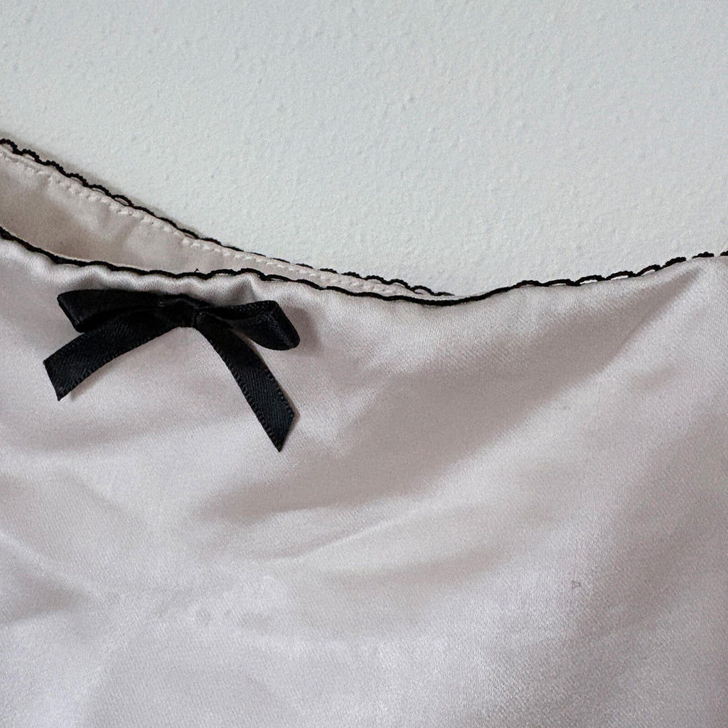 Elegant Cream Satin Camisole Top with Black Bow Accent