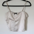 Elegant Cream Satin Camisole Top with Black Bow Accent